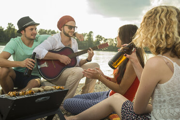 Young man with friends playing guitar - CUF38137