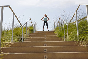 Woman standing at top of stairs - ISF15393