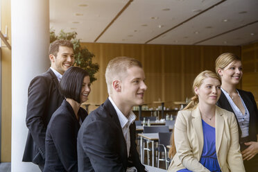 Businesswomen and men listening at business meeting in office - ISF15485