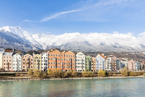 Austria, Innsbruck, row of houses in front of Nordkette Mountains with Inn River in the foreground stock photo
