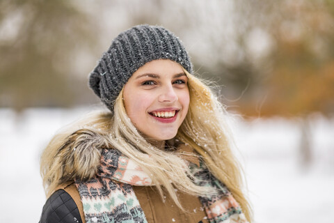 Portrait of smiling blond teenage girl in winter stock photo