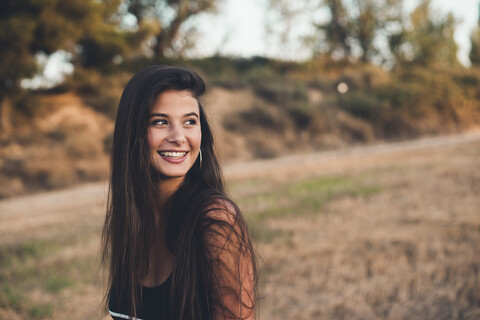 Portrait of laughing teenage girl in nature stock photo