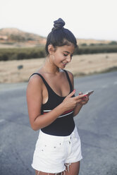 Teenage girl using smartphone outddors - ACPF00075