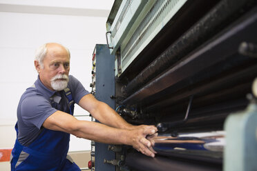 Fabrikarbeiter bei der Arbeit an Maschinen - CUF38766