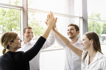 Businessmen and businesswomen cheering - CUF38811