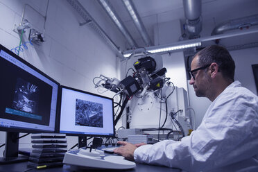Lab assistant working with SEM image on computer - CUF38850