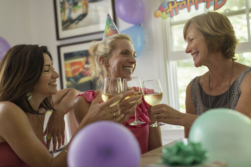 Three mature women toasting with wine glasses - ISF15707