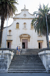Rückansicht eines jungen Paares mit Blick auf die Kirche, Milna, Brac, Kroatien - ISF15785