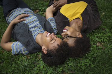 Two mature female friends lying on park grass - ISF15814