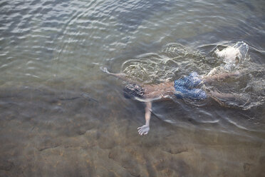 Hochformatige Ansicht eines Teenagers, der im Lake Superior, Au Train, Michigan, USA, unter Wasser schwimmt - ISF15829