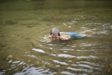 Teenage boy submerged in river, Canton, North Carolina, USA - ISF15844