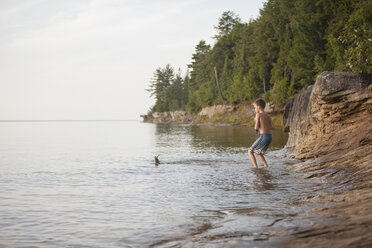 Teenage boy catching fish in Lake Superior, Au Train Bay, Michigan, USA - ISF15847