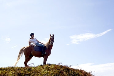 Horse rider on hilltop, Pakiri Beach, Auckland, New Zealand - ISF16041