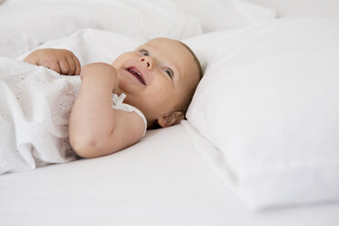 Baby girl lying on bed - CUF39064