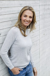 Mature woman by clapboard wall, portrait - CUF39163