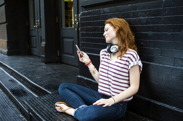 Portrait of young woman using mobile phone - ISF16520