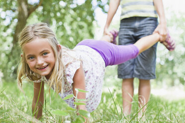 Father and daughter playing in park - CUF39233