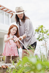 Mother and daughter gardening - CUF39273