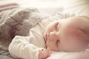 Two month old baby boy asleep in crib - CUF39394