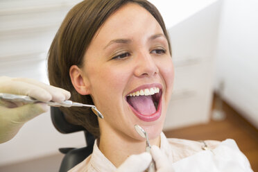 Woman having check up at dentists with mouth open - CUF39430