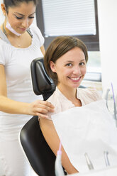 Young woman in dentists chair with dental nurse - CUF39433