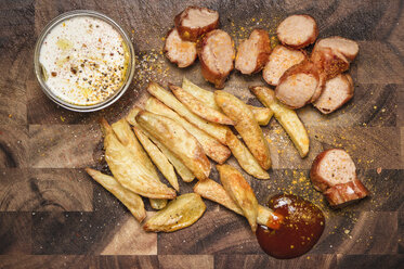 Still life of potato fries, ketchup and currywurst - CUF39524