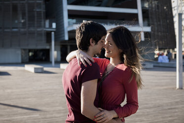 Affectionate young couple standing on city square - MAUF01452