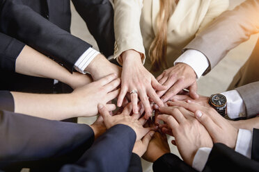 Hands of group of businesswomen and men together in a circle - ISF16578