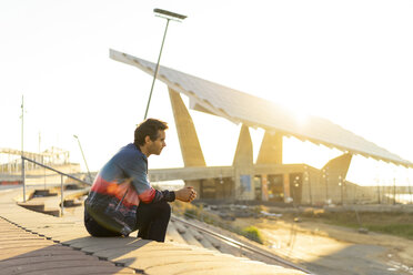 Man sitting on stairs in the morning, looking worried - AFVF00679