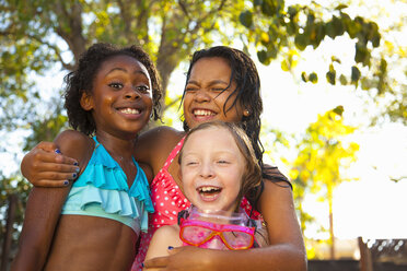 Three girls laughing in garden - ISF16786