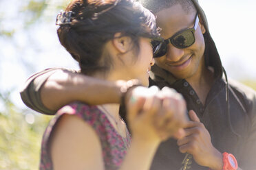 Close up of romantic young couple holding hands - ISF16843