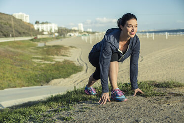 Jogger on her mark by beach - ISF16866