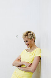 Smiling woman wearing yellow shirt - CUF39658