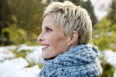 Woman wearing knitted scarf outdoors - CUF39665