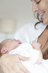 Mother cradling infant son - CUF39675