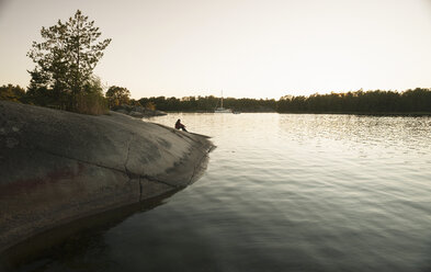 Silhouette of person on river bank - CUF39715