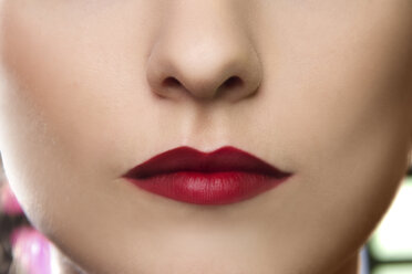 Cropped studio portrait of young woman's lips - CUF39802