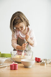 Girl mixing batter in bowl - CUF39905