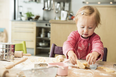 Baby girl baking in kitchen - CUF39917