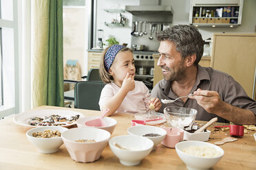 Father and daughter baking in kitchen - CUF39920