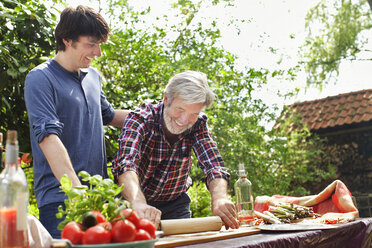 Father and adult son making pizza - CUF40061