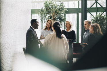 Multi-ethnic business people standing at office - MASF08068