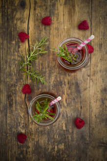 Two glass bottles of homemade raspberry lemonade flavoured with rosemary - LVF07236