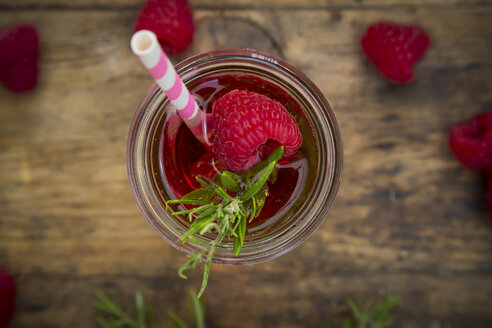 Glass bottle of homemade raspberry lemonade flavoured with rosemary - LVF07237
