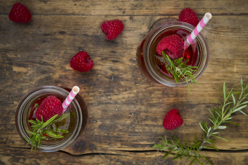 Two glass bottles of homemade raspberry lemonade flavoured with rosemary - LVF07240