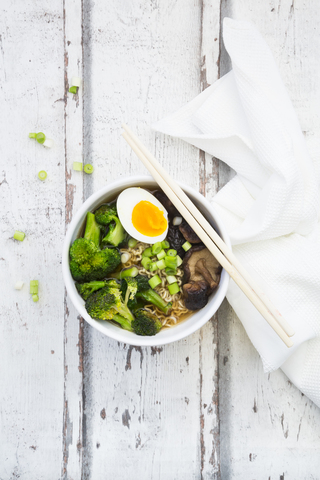 Bowl of Ramen soup with egg, broccoli, noodles, shitake mushroom and spring onions stock photo