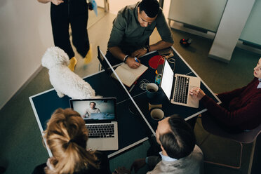 High angle view of multi-ethnic business colleagues discussing in board room at creative office - MASF08275