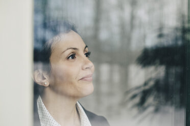 Close-up of thoughtful businesswoman seen through glass window at office - MASF08348