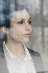 Close-up of thoughtful businesswoman seen through glass window at office - MASF08349