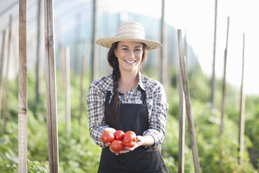 Woman holding tomatoes grown at farm - CUF40146
